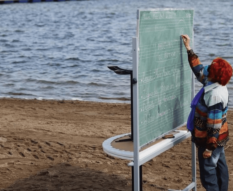 Niños toman clase en la playa, debido a pandemia en España