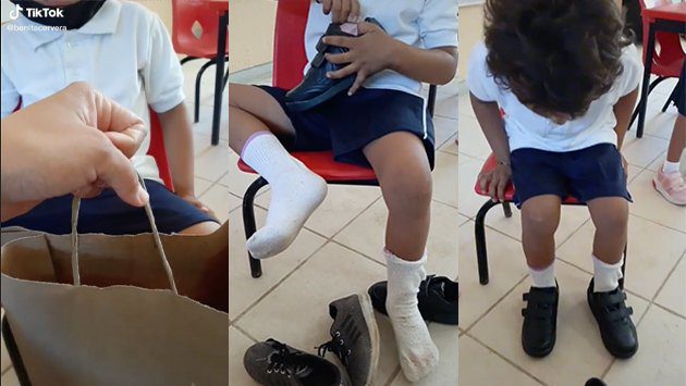 Maestra le regala unos zapatos nuevos a un alumno