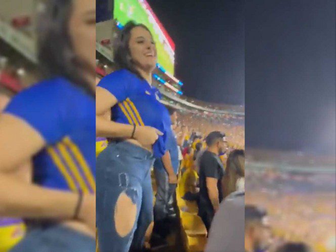 Aficionada de Tigres festeja un gol levantándose la playera