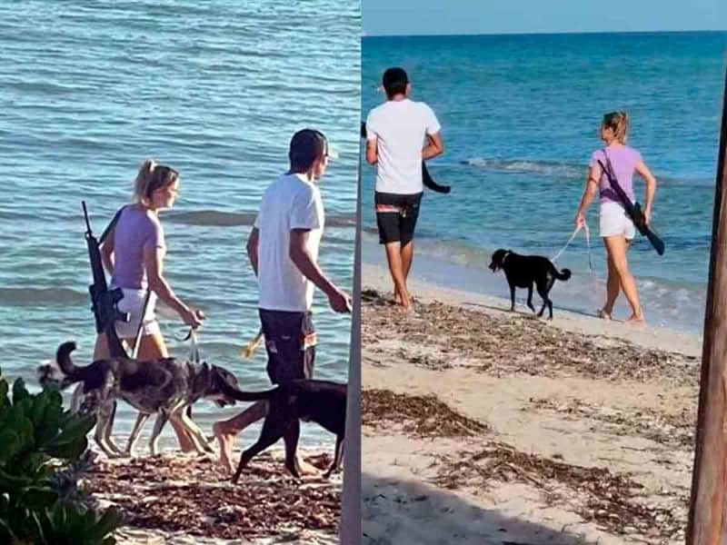 Mujer se pasea por la playa de Yucatán portando un rifle