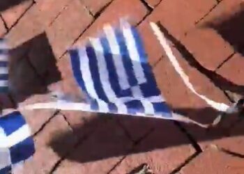 Mujer confunde banderas de Grecia con las de Israel y las derriba