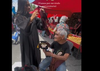 Con toga y diploma, joven agradece a su abuelo en el tianguis Agua Azul